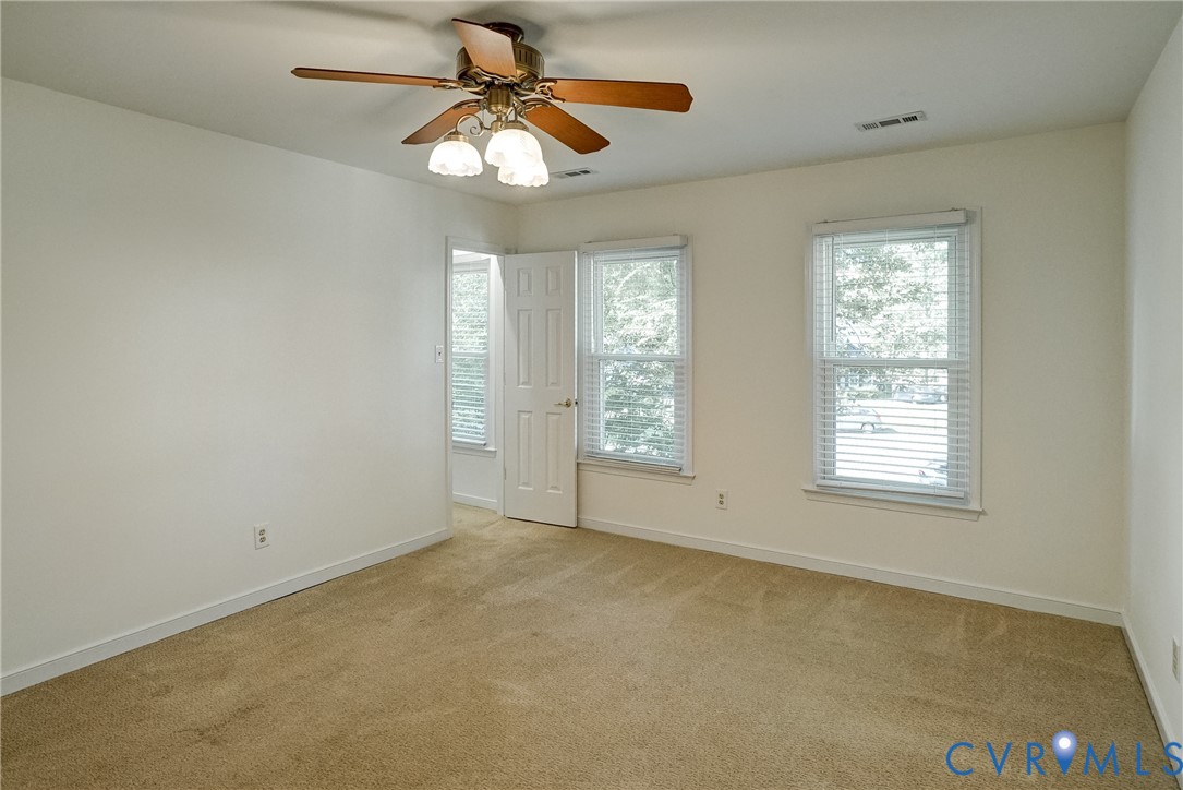 Freshly painted primary has walk in closet and en-suite bath