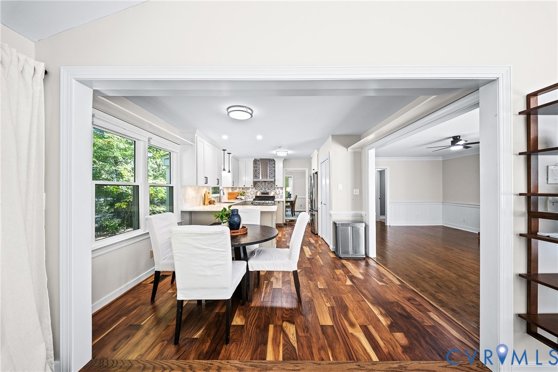 Kitchen featuring white cabinetry, wood-finish flooring, recessed lighting, and stainless steel range hood