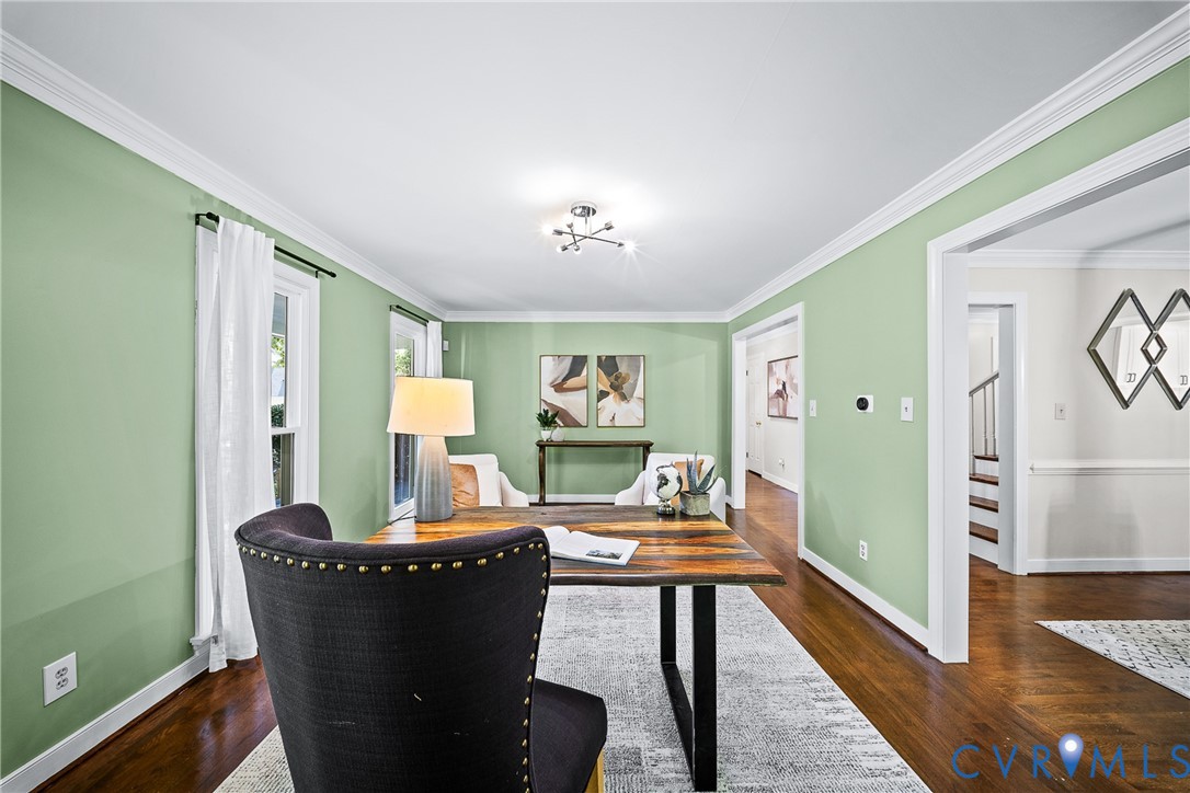 Hardwood flooring, crown molding, and multi-light ceiling fixture