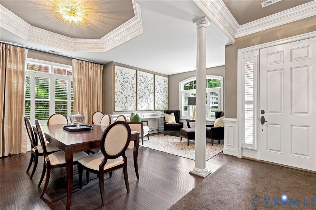 Hardwood flooring, decorative ceiling, double entry doors, interior column, and transom windows