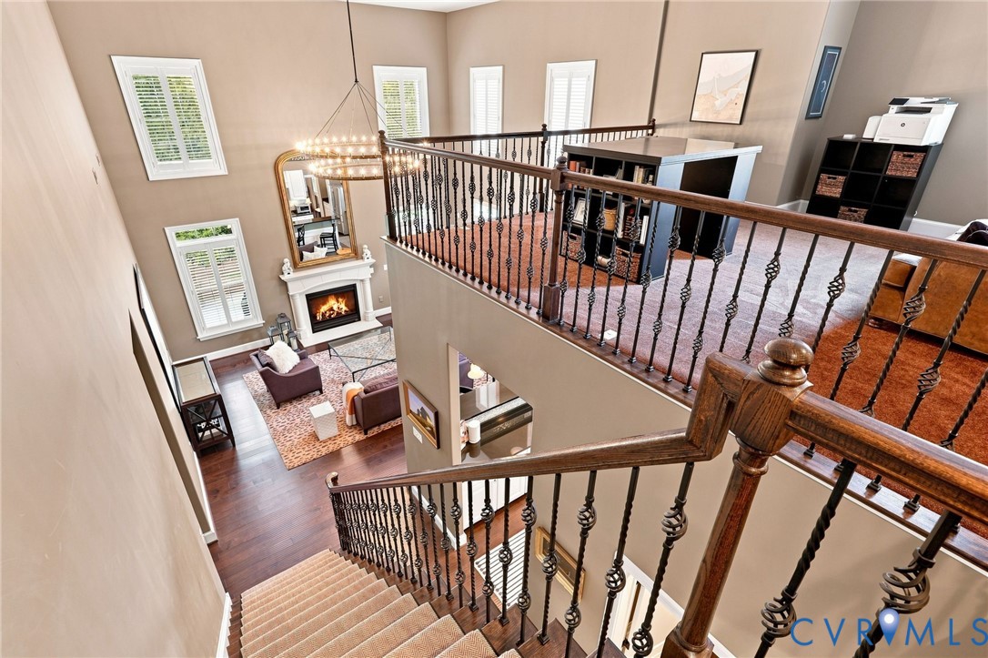 Two-story living area with fireplace and decorative mantel