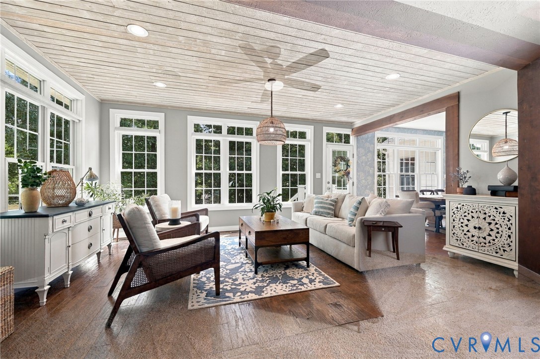 Wood-finish flooring, planked ceiling with recessed lighting, multiple transom windows, and an open entryway