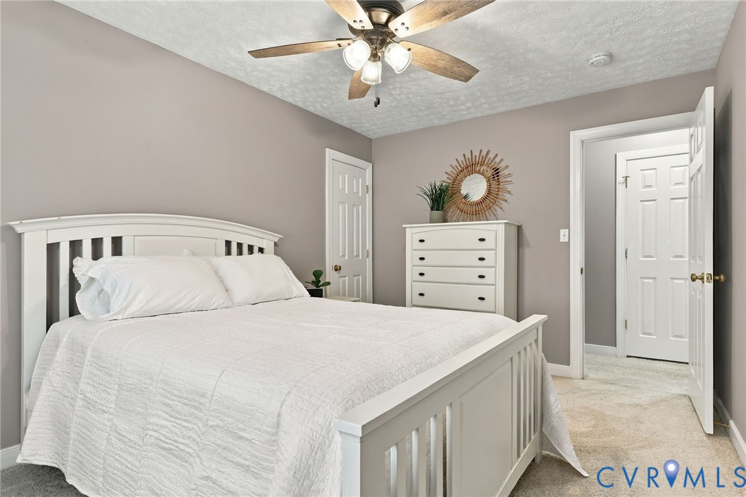 Neutral-toned walls complement plush carpeting