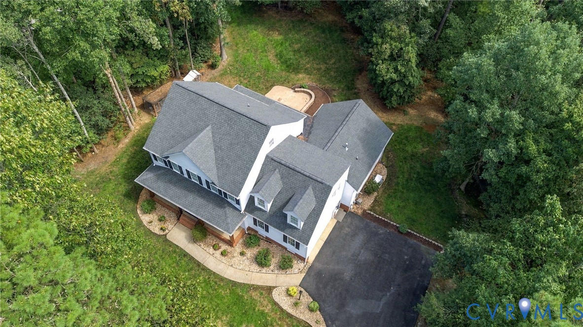 White two-story exterior with a gray shingle roof and dormer windows