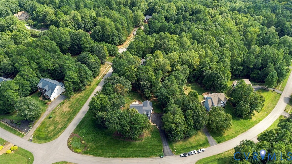 Wooded surroundings with established residential properties and paved roadways