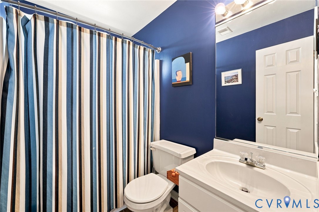 Vanity with an integrated sink, polished chrome faucet, and a wall-mounted mirror