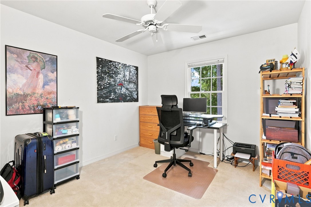 Recessed window, ceiling fan, and light-colored wall-to-wall carpeting