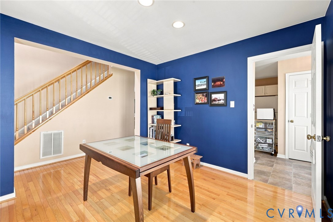 Hardwood flooring throughout, recessed lighting, and a built-in shelving unit