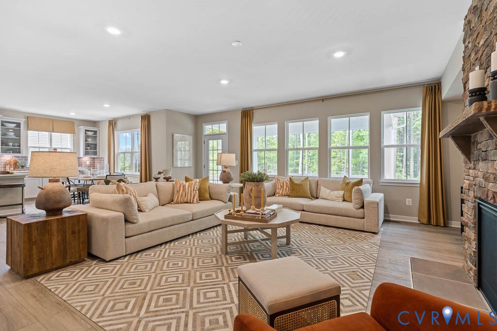 Open-concept living space with recessed lighting and wood-finish flooring