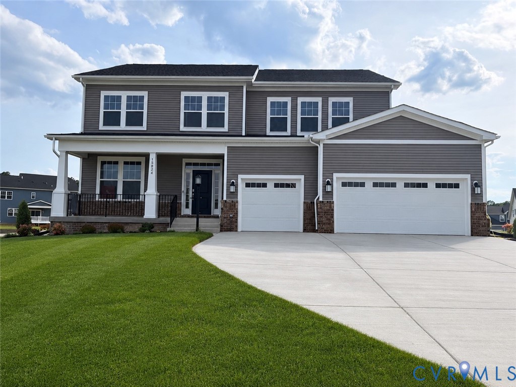 Two-story residence featuring grey horizontal siding, white trim, a covered front porch with white columns, and an integrated two-car garage with white doors