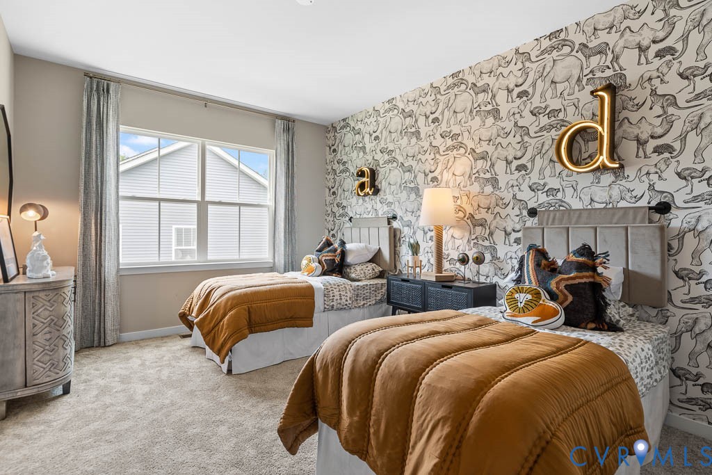 Spacious room with a large window, textured wallpaper, and two upholstered headboards