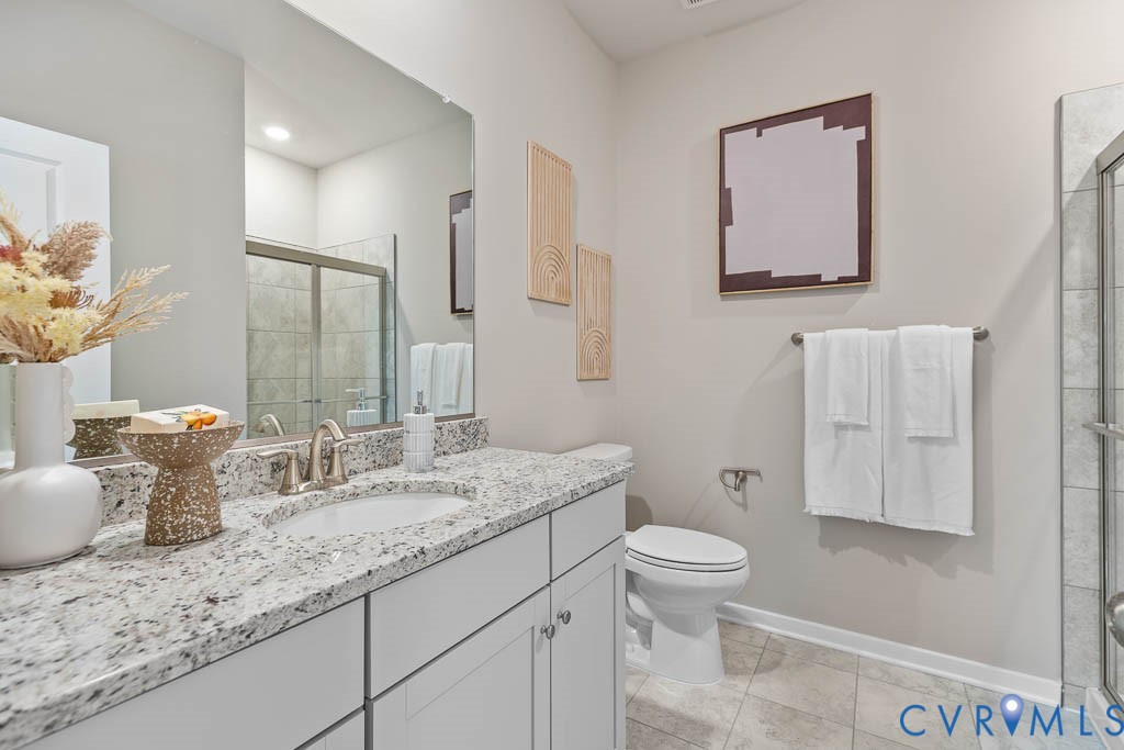 Vanity with a granite countertop and an undermount sink