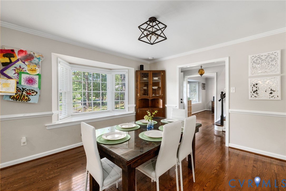 Hardwood flooring, bay window, crown molding, and chair rail molding. Hardwood flooring, bay window, crown molding, and chair rail molding.