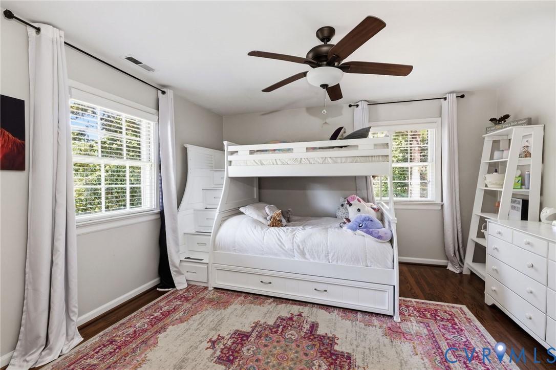 Hardwood-finish flooring, recessed lighting, and a ceiling fan with integrated lighting