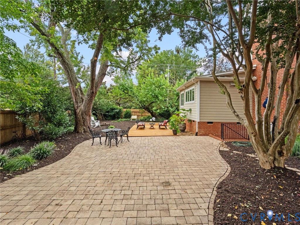 Expansive side yard with mature landscaping, sprinklers and hardscaping. Even an outdoor shower!