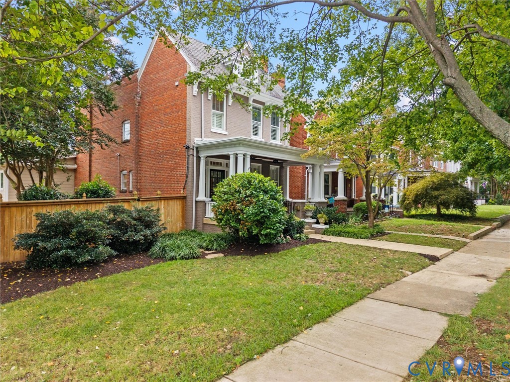 Brick & slate with expansive front porch & side yard