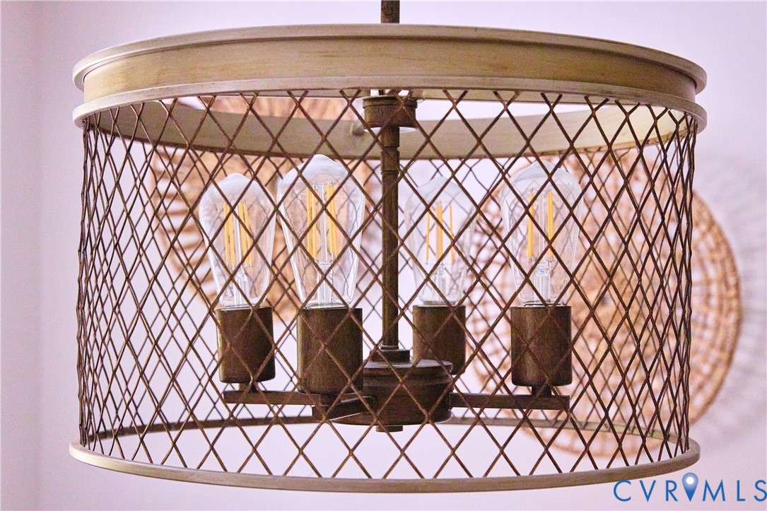 Industrial-style pendant light with a distressed metal cage and exposed filament bulbs
