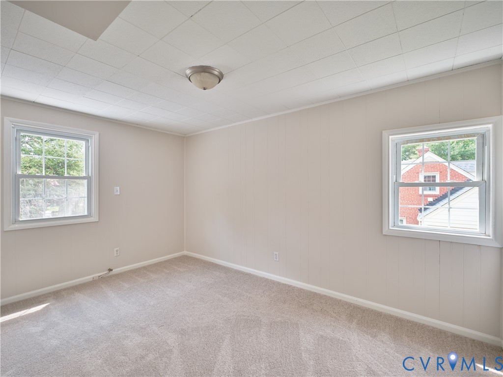 Neutral tone wall paneling with carpet flooring