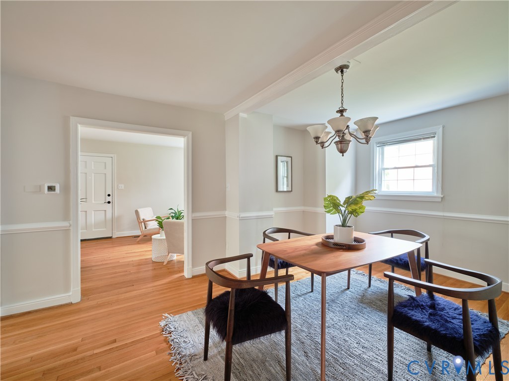 Hardwood flooring, crown molding, chair rail molding, recessed lighting, and a multi-light chandelier