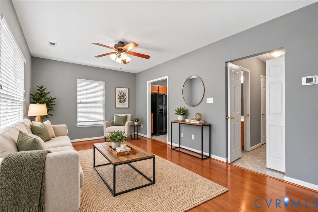 Hardwood-finish flooring, recessed lighting, and a ceiling fan with light fixture