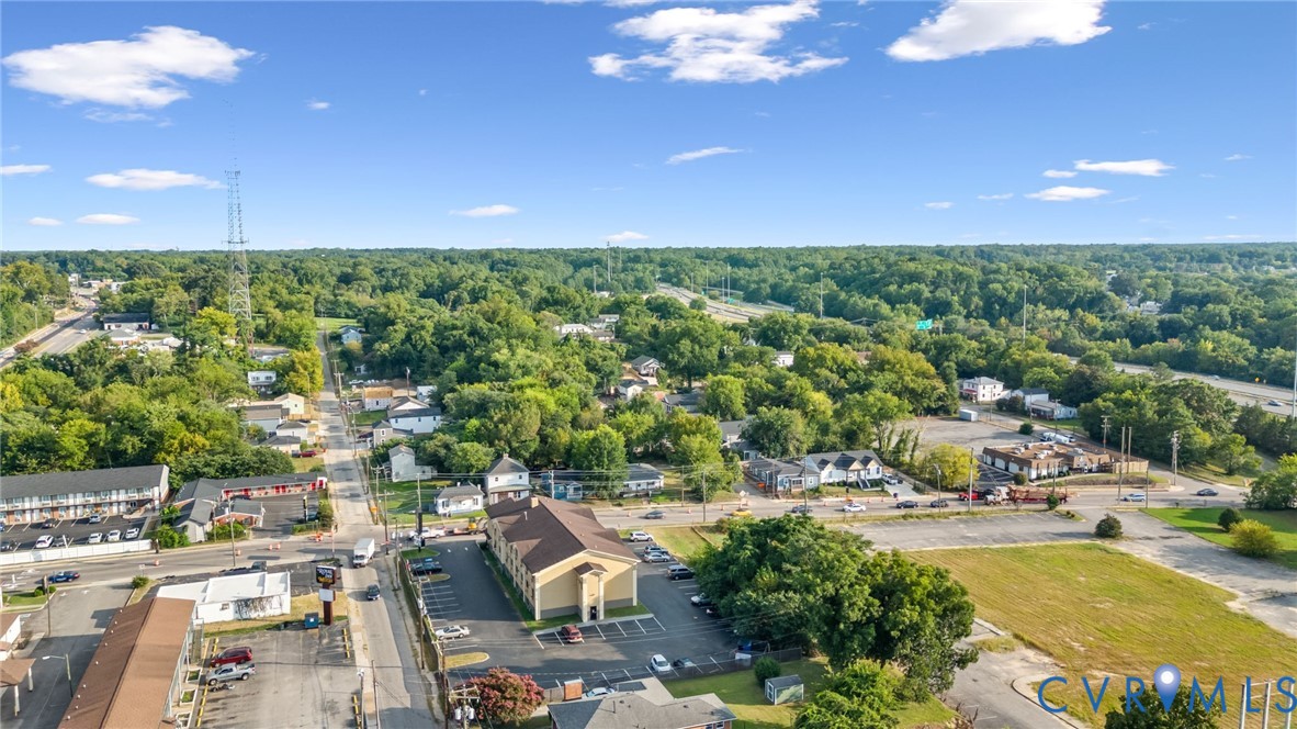 Aerial perspective of a developed area with extensive tree coverage and visible roadways