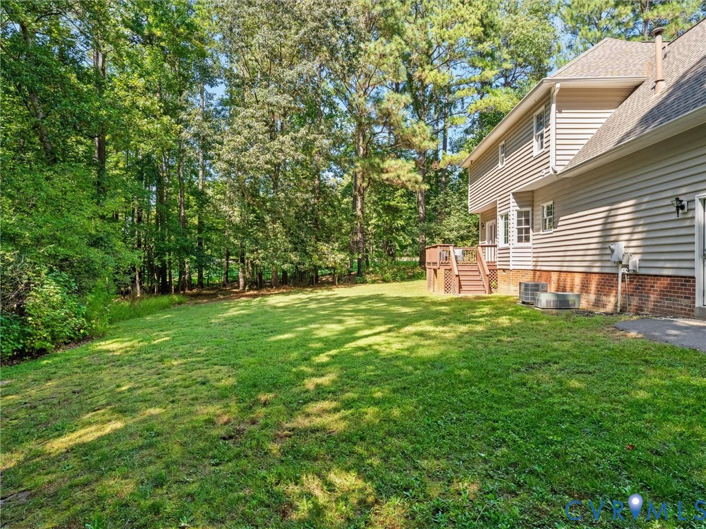 Expansive grassy yard with mature trees