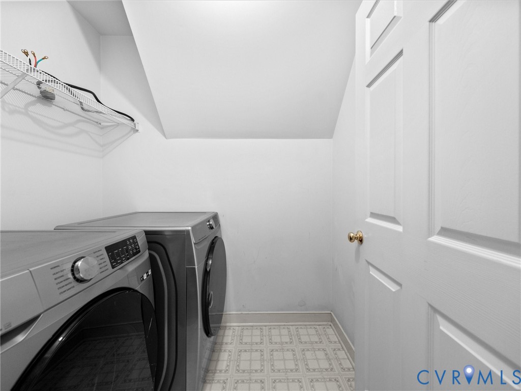 Dedicated laundry area with a wire shelf and patterned flooring