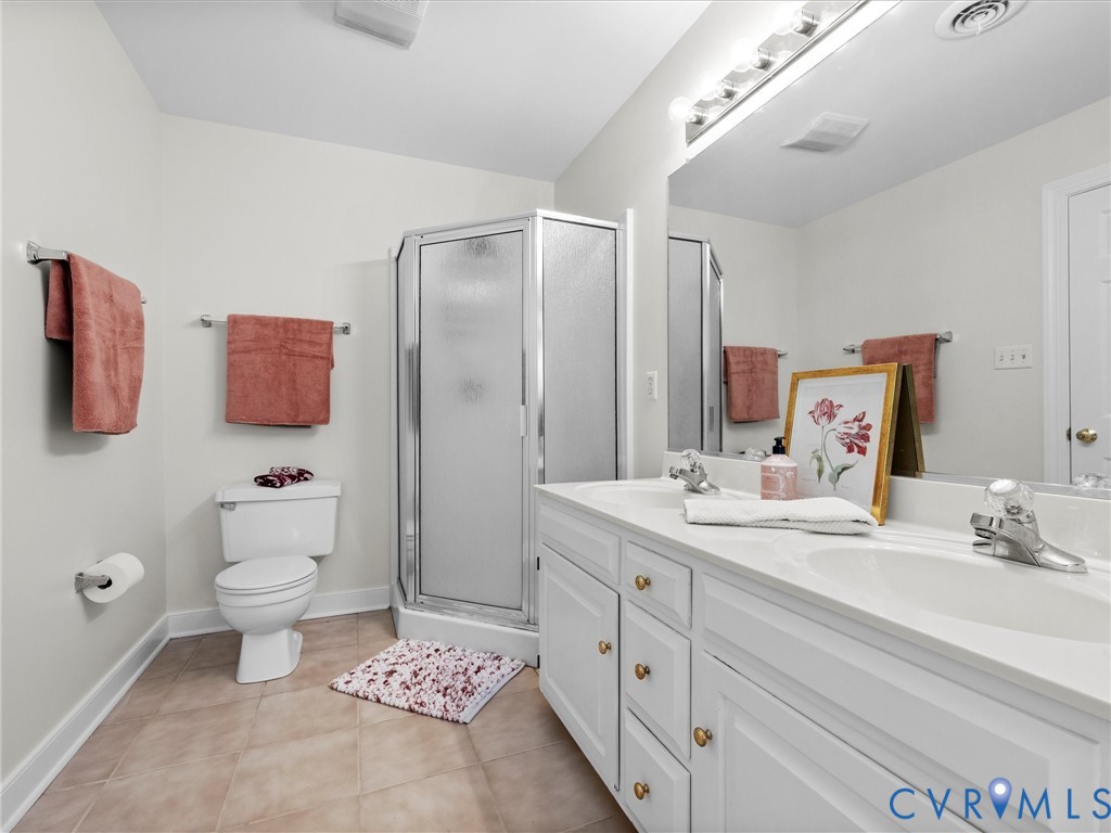 White dual vanity with integrated sinks, chrome faucets, and brass-finish hardware