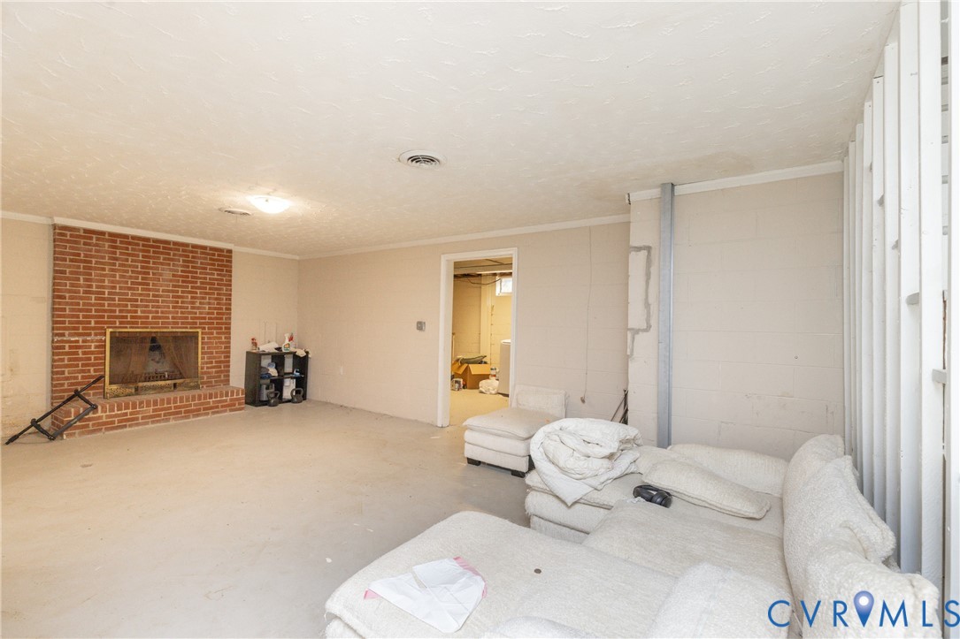 Another view of basement w/fireplace
