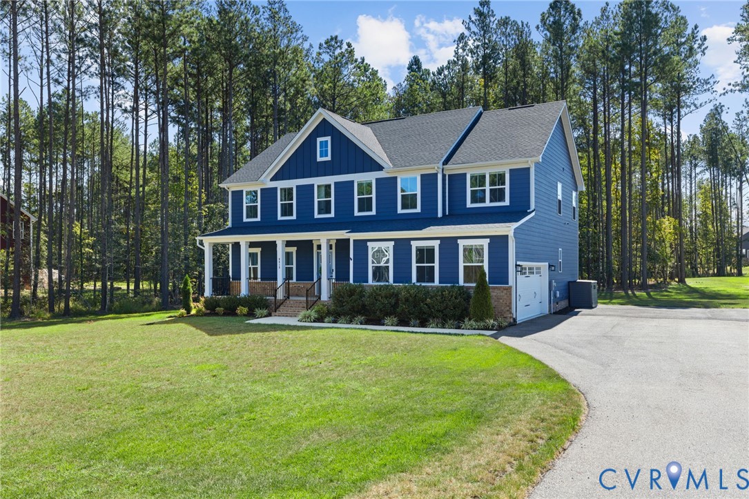 Two-story residence featuring blue siding, white trim, and a covered front porch with white columns