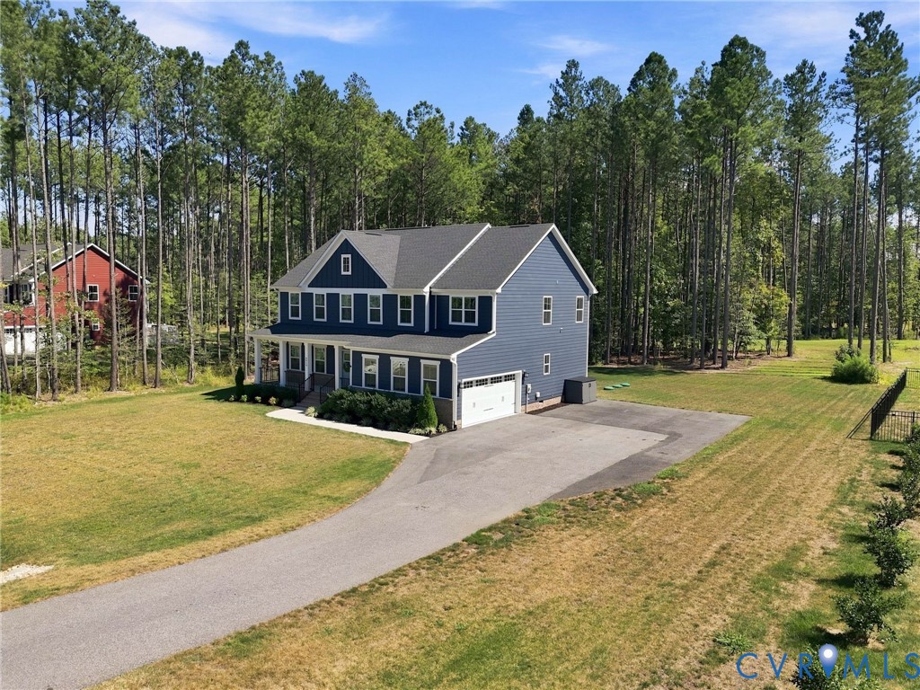 Two-story residence with blue siding, a covered front porch, and an attached two-car garage