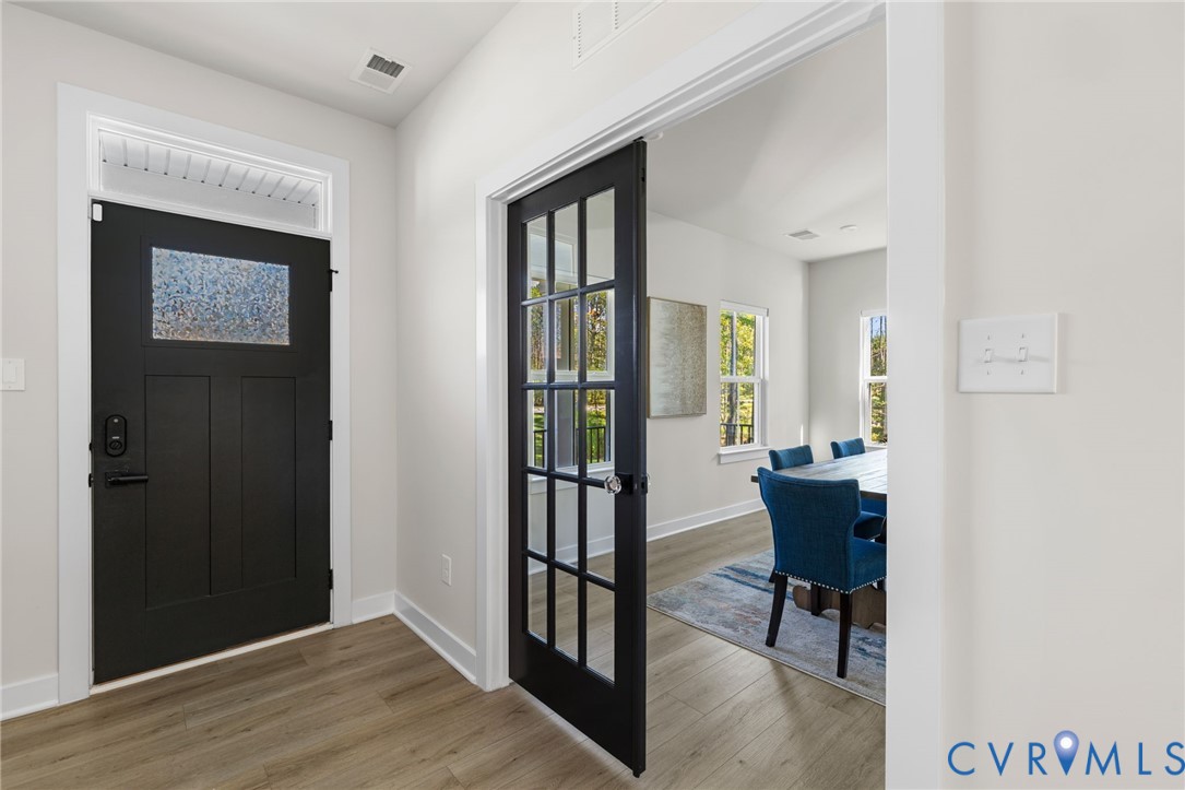 Black entry door with frosted glass insert and transom window