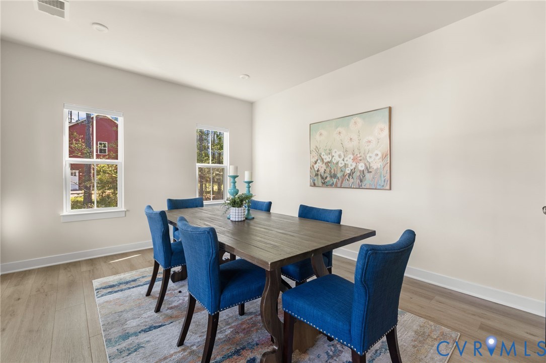 Recessed lighting, wood-finish flooring, white trim, and light-toned walls