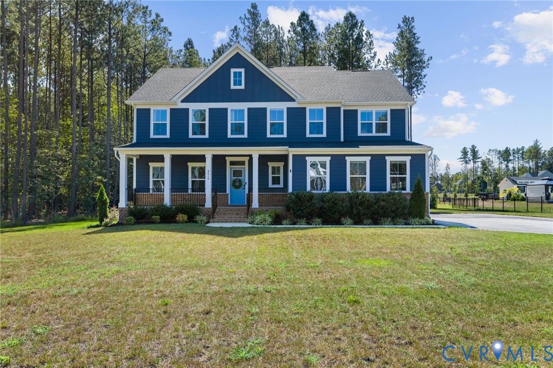 Two-story residence featuring a blue siding exterior, white trim, and a covered front porch with white columns