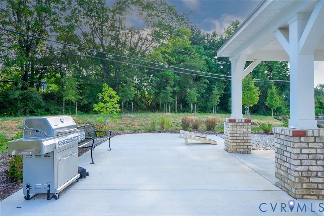 Covered patio area with brick-clad columns and a concrete surface
