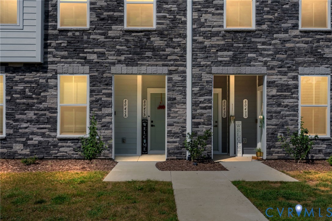 Stone-clad exterior with multiple windows and light-colored siding accents