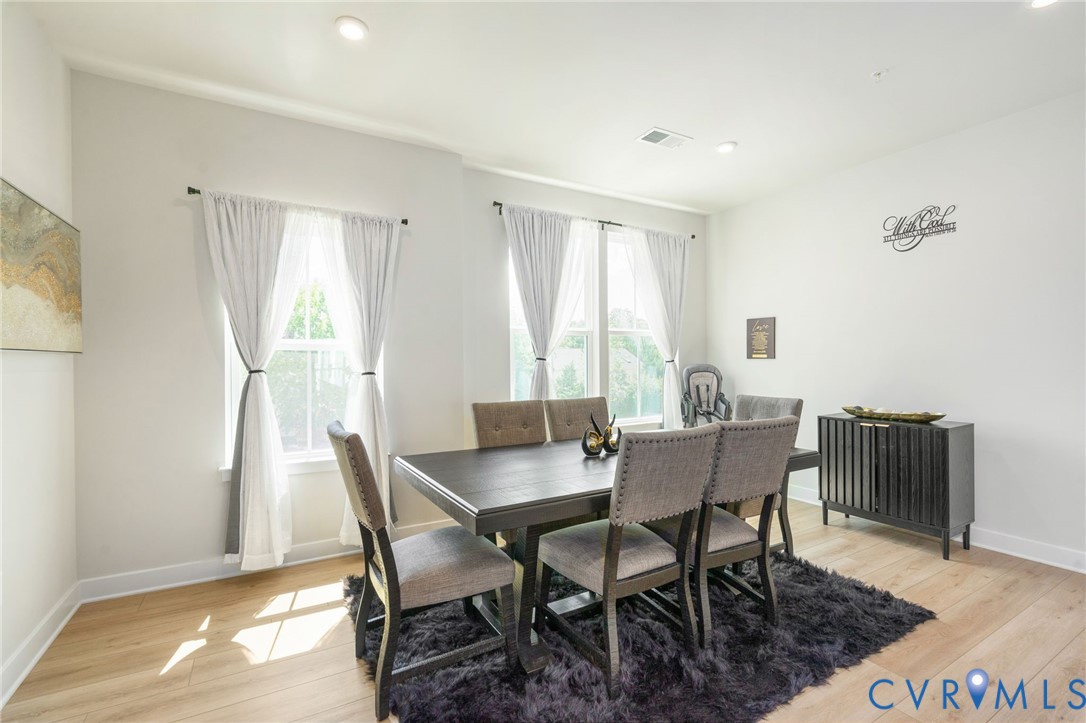 Recessed lighting, light wood-finish flooring, and multiple windows