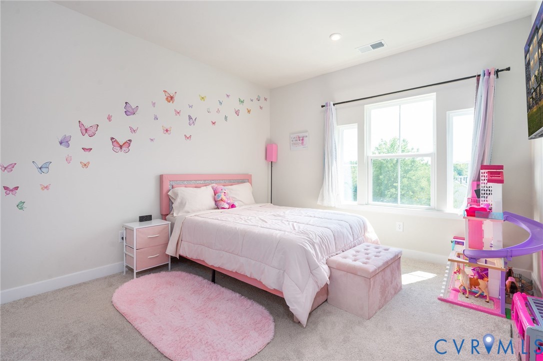 Recessed ceiling lighting, multiple large windows, wall-to-wall carpeting, and painted walls