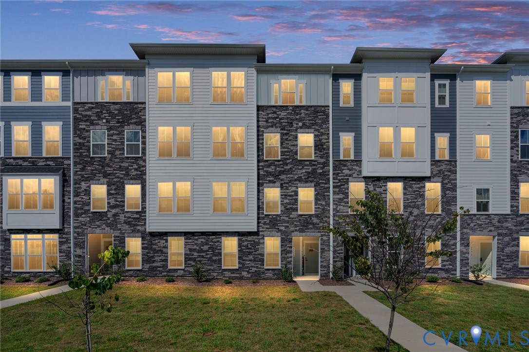 Modern multi-story exterior with stone and siding accents