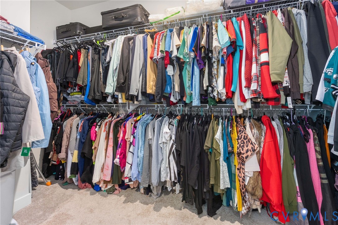 Custom closet system featuring multiple hanging rods and integrated shelving