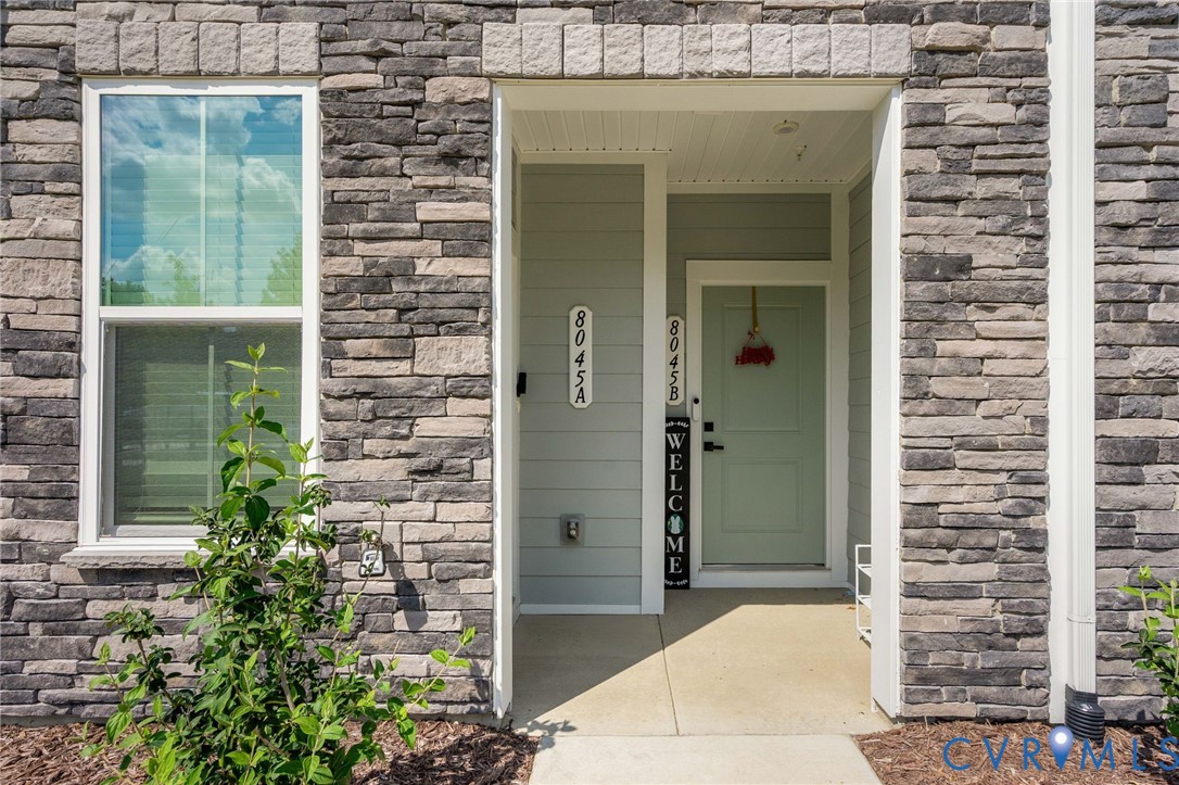 Stone veneer exterior with a covered entry