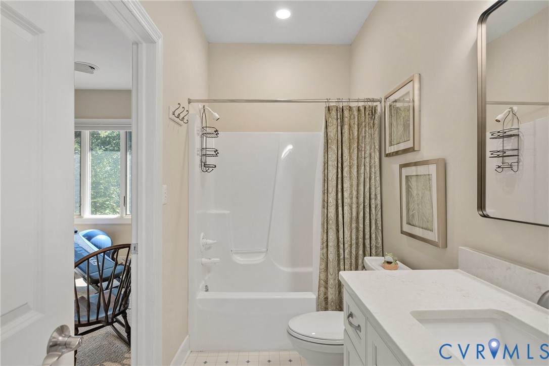 Full bathroom with a single vanity, a built-in tub and shower combination, and a recessed light fixture