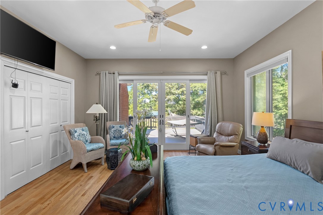 Hardwood flooring, recessed lighting, ceiling fan, bi-fold closet doors, and sliding glass door access to an outdoor deck