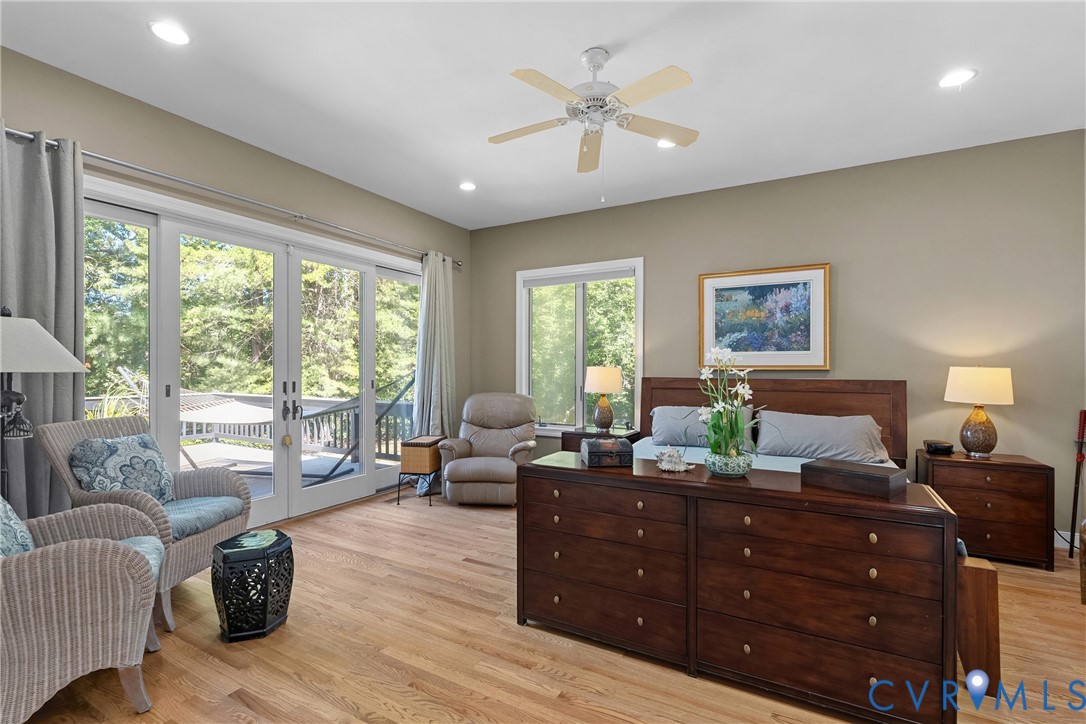 Hardwood flooring, recessed lighting, ceiling fan, and sliding glass doors opening to an outdoor deck
