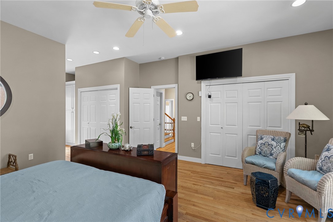 Hardwood flooring, recessed lighting, ceiling fan, bi-fold closet doors, and a wall-mounted television
