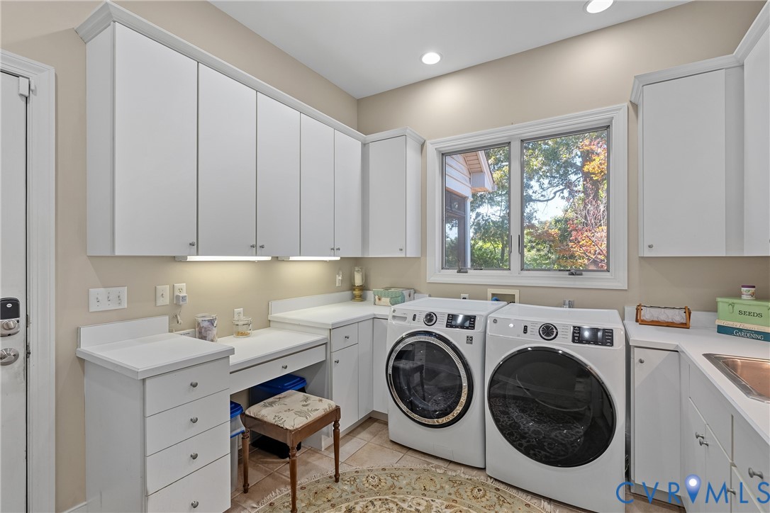 White cabinetry and countertops with integrated sink