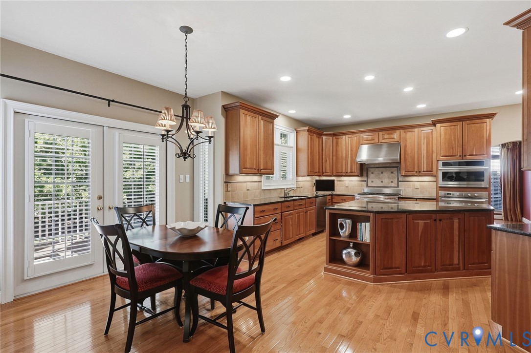 Hardwood flooring, wood cabinetry, granite countertops, stainless steel appliances, and recessed lighting Hardwood flooring, wood cabinetry, granite countertops, stainless steel appliances, and recessed lighting