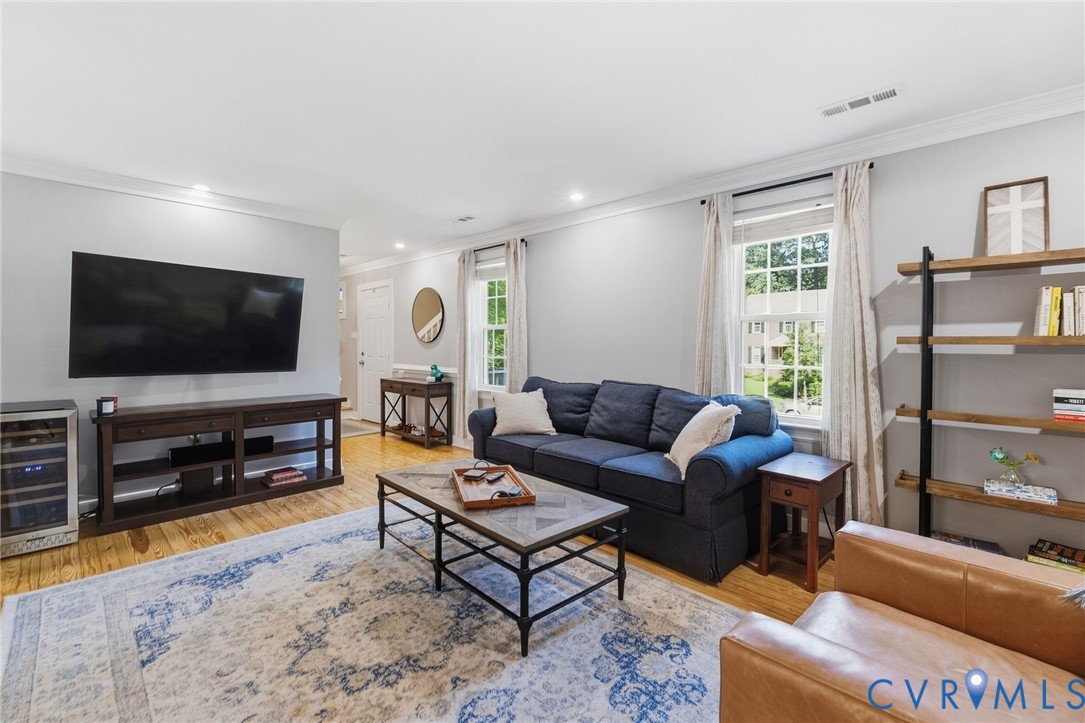 Hardwood flooring throughout, recessed lighting, and crown molding