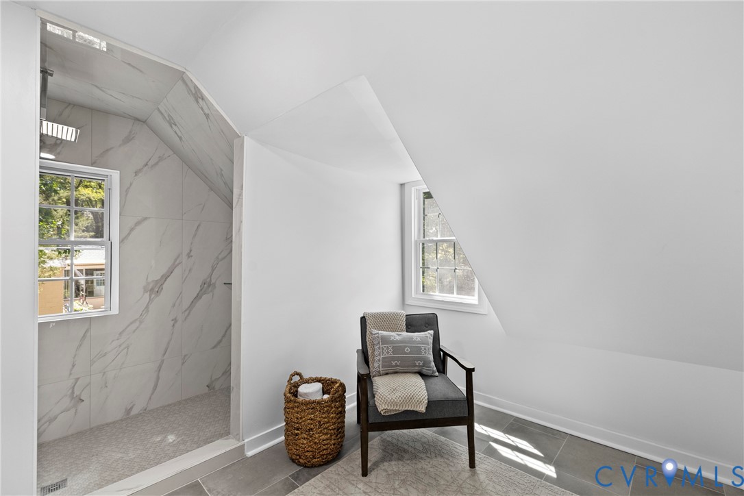 Walk-in shower with large format tile surround and rainfall showerhead