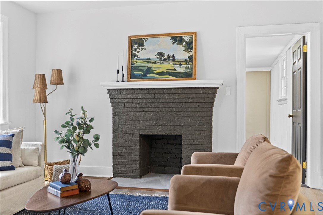 Brick fireplace with white mantel and hearth